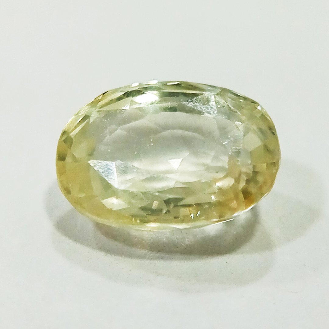 A high-quality Yellow Sapphire stone, known for its astrological benefits and association with Jupiter.