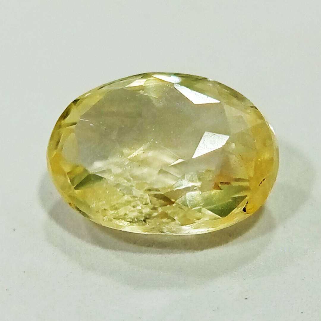 A high-quality Yellow Sapphire stone, known for its astrological benefits and association with Jupiter.