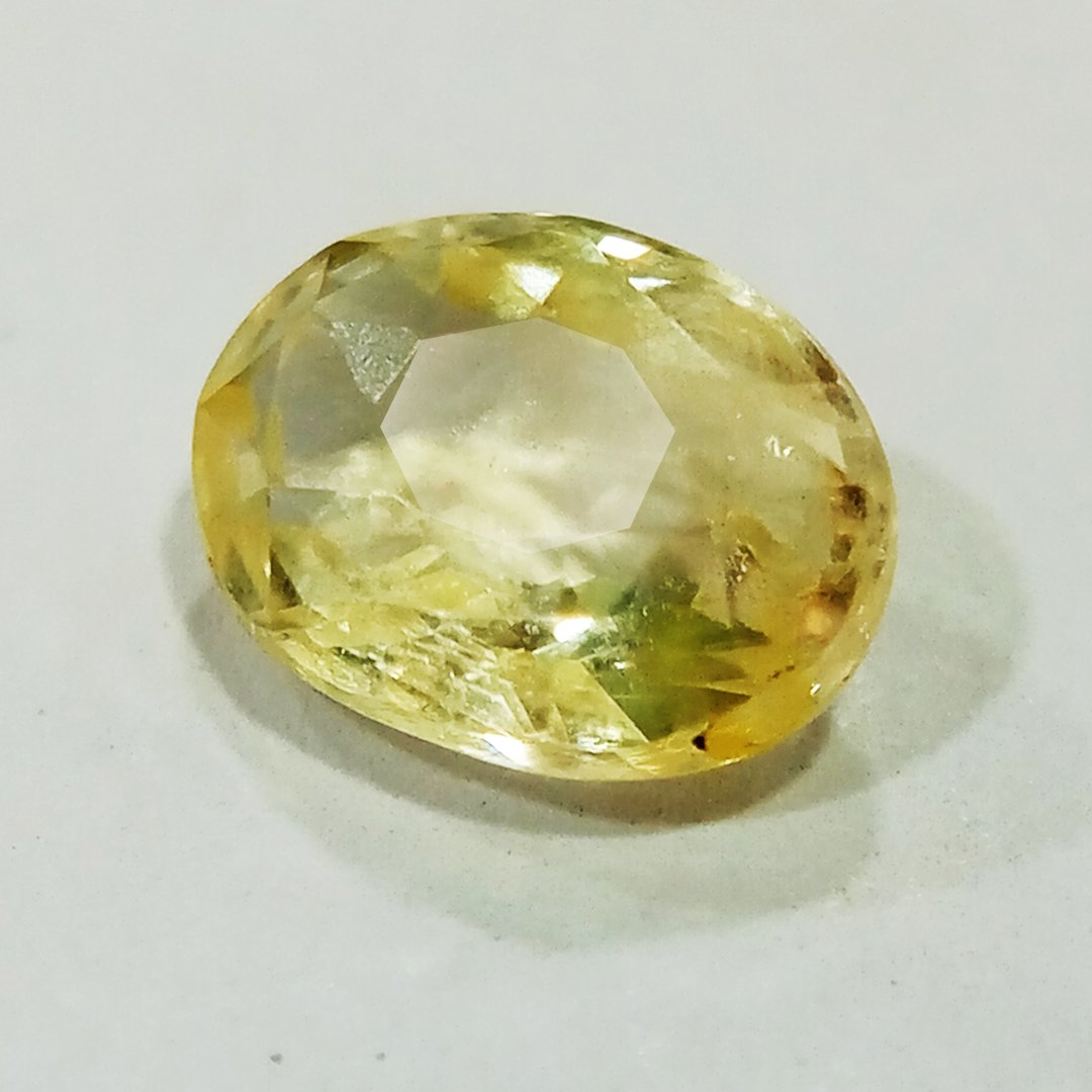 A high-quality Yellow Sapphire stone, known for its astrological benefits and association with Jupiter.
