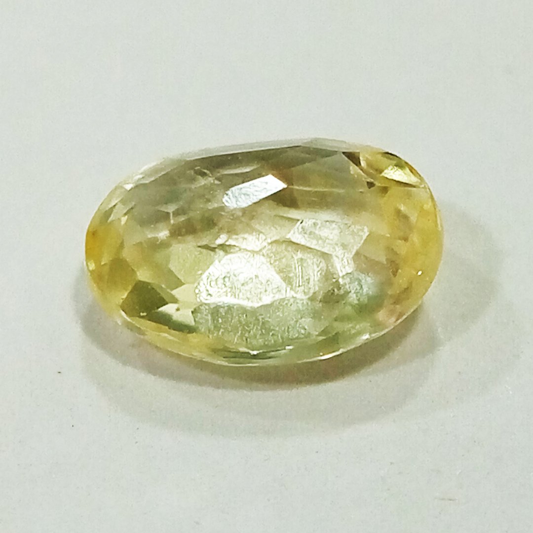 A high-quality Yellow Sapphire stone, known for its astrological benefits and association with Jupiter.