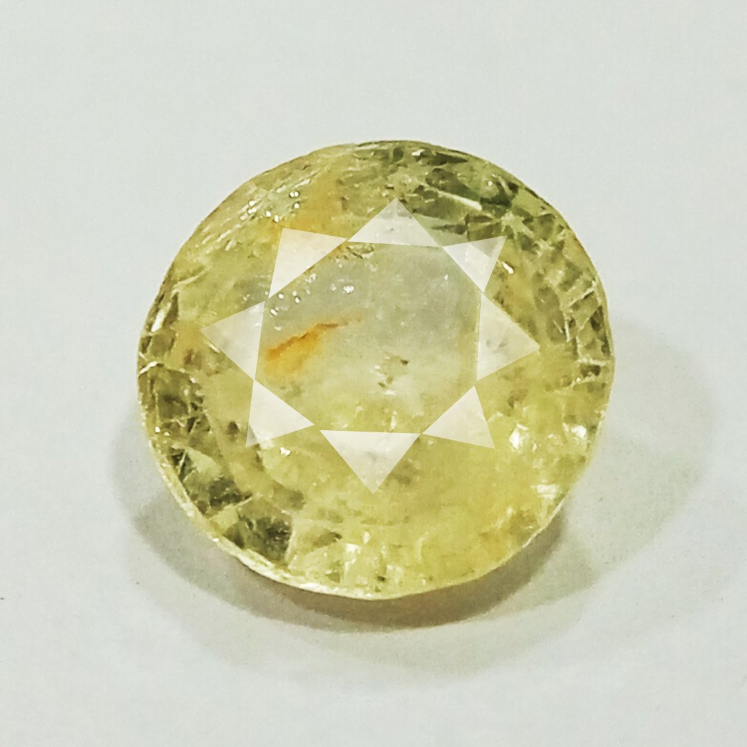 A high-quality Yellow Sapphire stone, known for its astrological benefits and association with Jupiter.