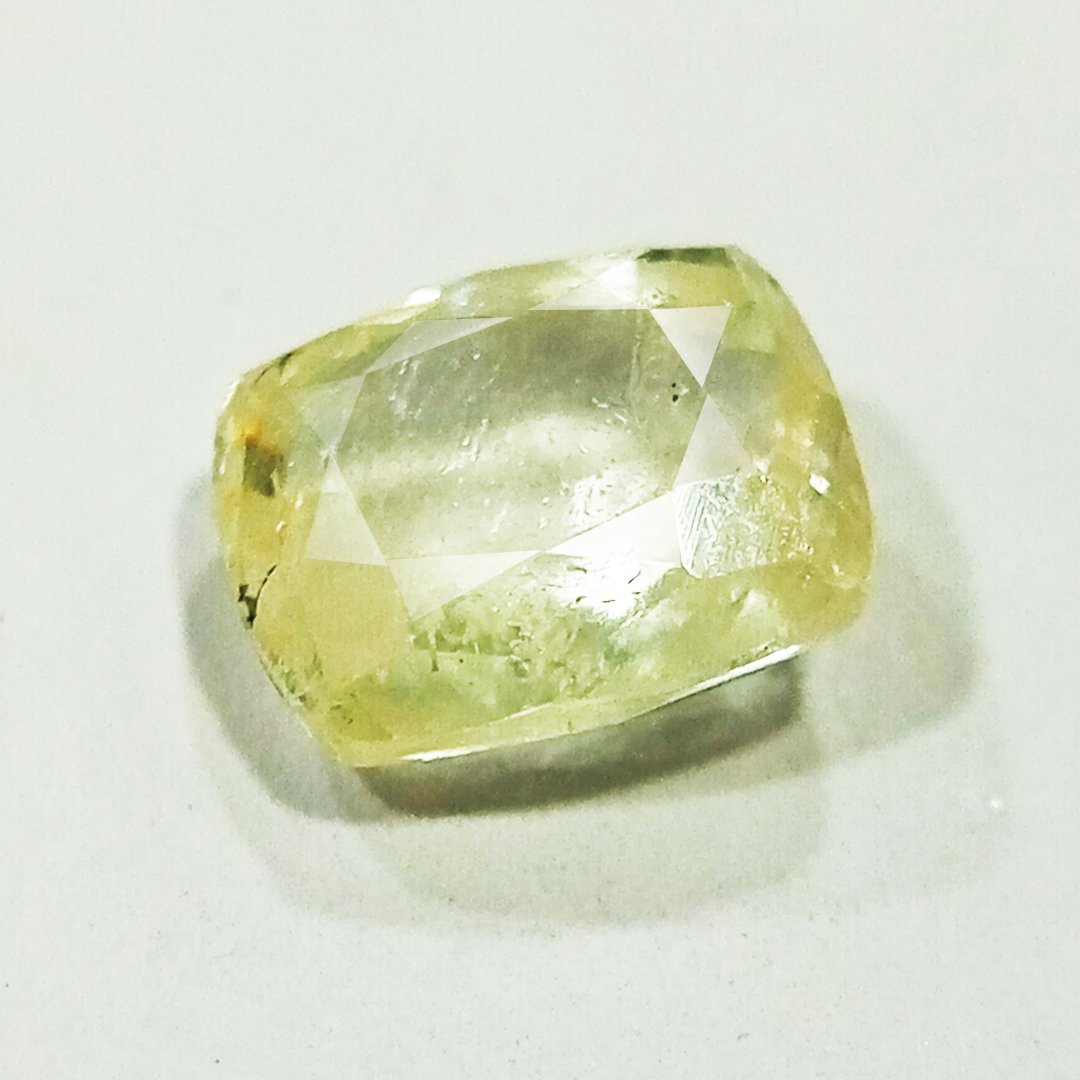 A high-quality Yellow Sapphire stone, known for its astrological benefits and association with Jupiter.