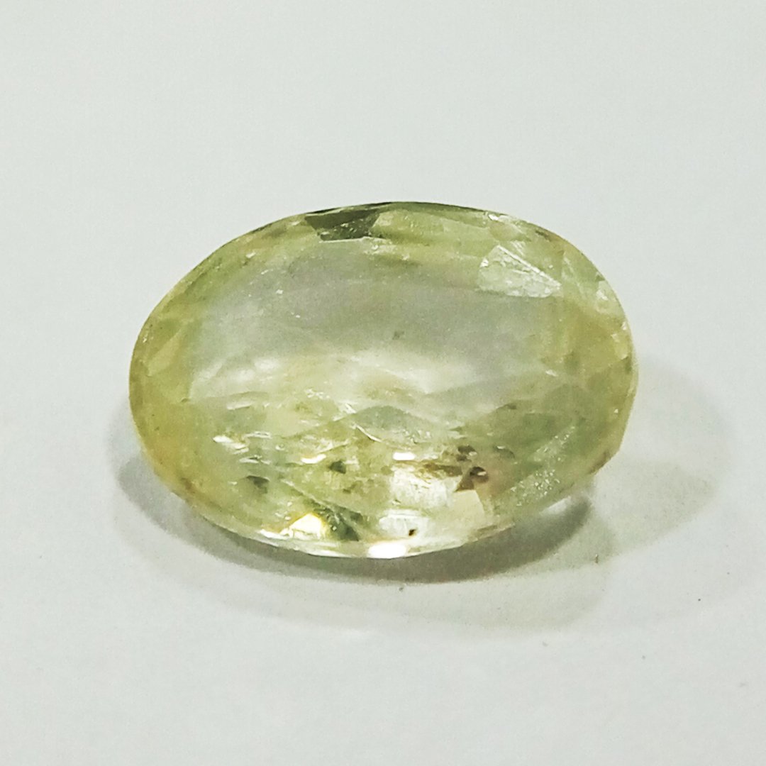 A high-quality Yellow Sapphire stone, known for its astrological benefits and association with Jupiter.