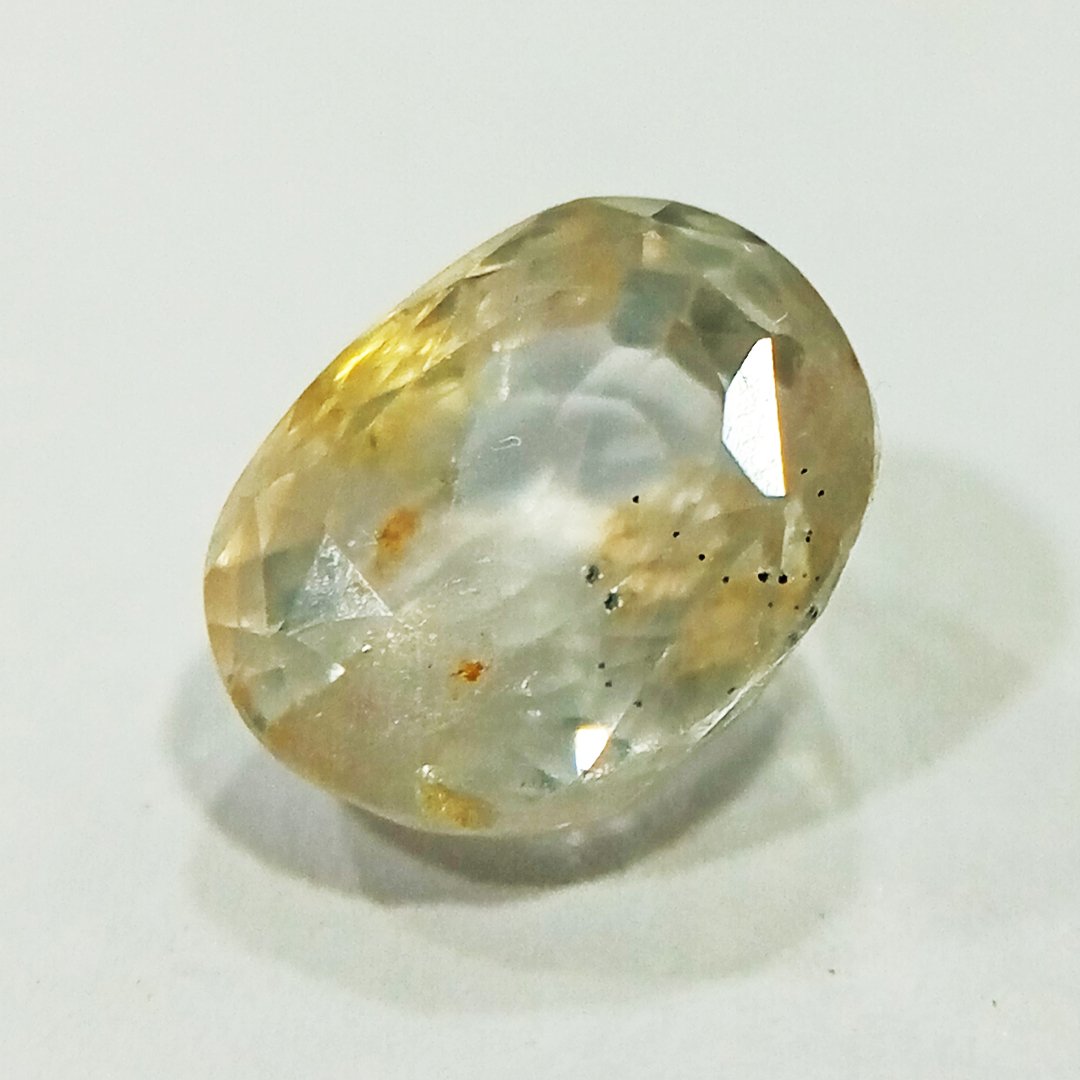 A high-quality Yellow Sapphire stone, known for its astrological benefits and association with Jupiter.