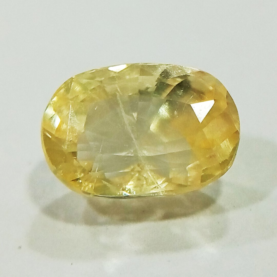 A high-quality Yellow Sapphire stone, known for its astrological benefits and association with Jupiter.