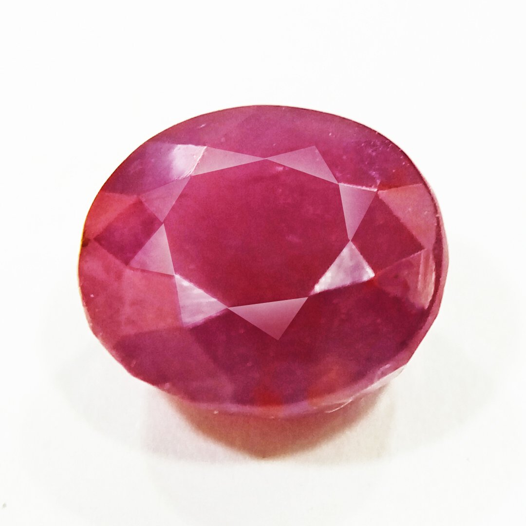 A close-up of a Natural African Ruby gemstone showcasing its rich red hue and brilliant clarity.