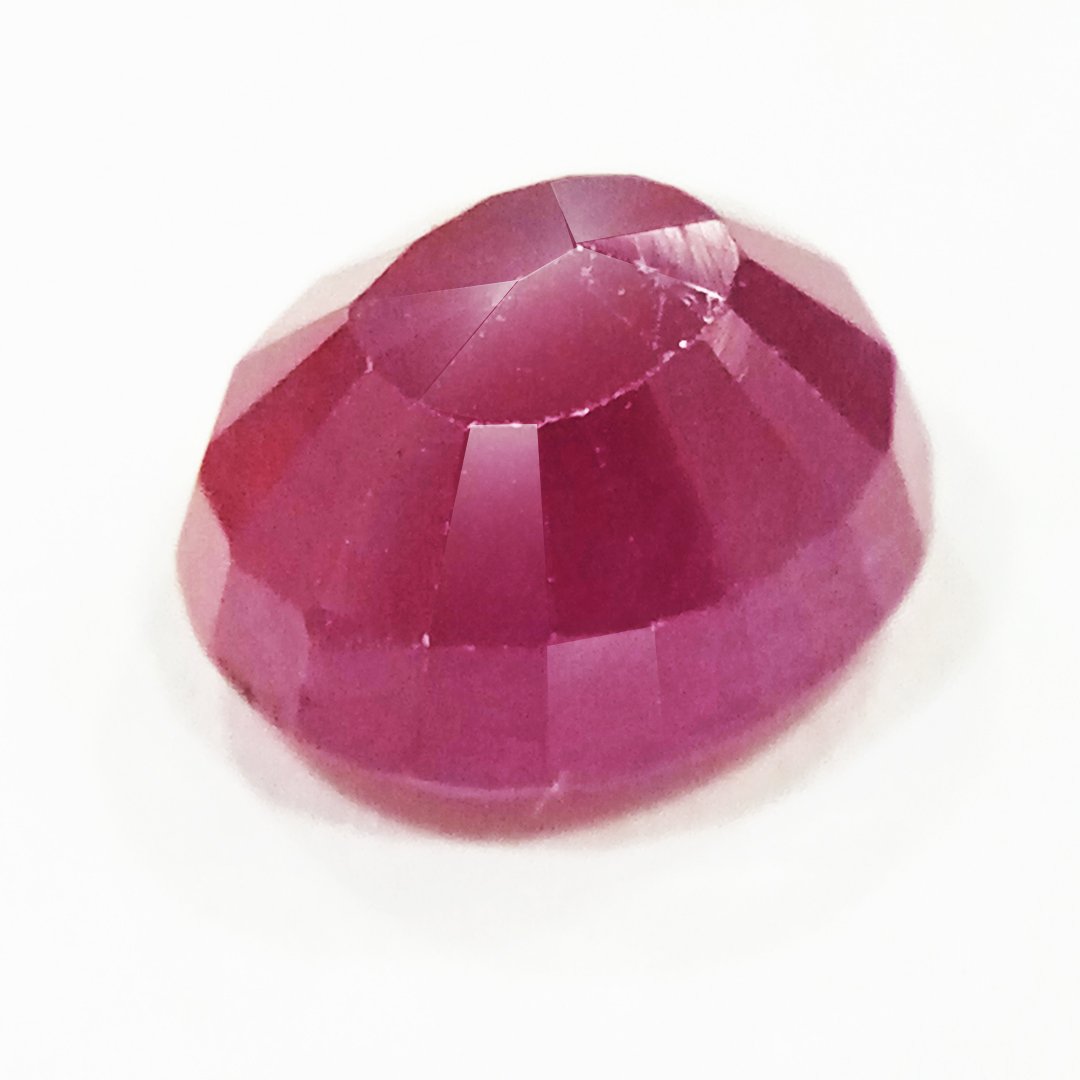 A close-up of a Natural African Ruby gemstone showcasing its rich red hue and brilliant clarity.