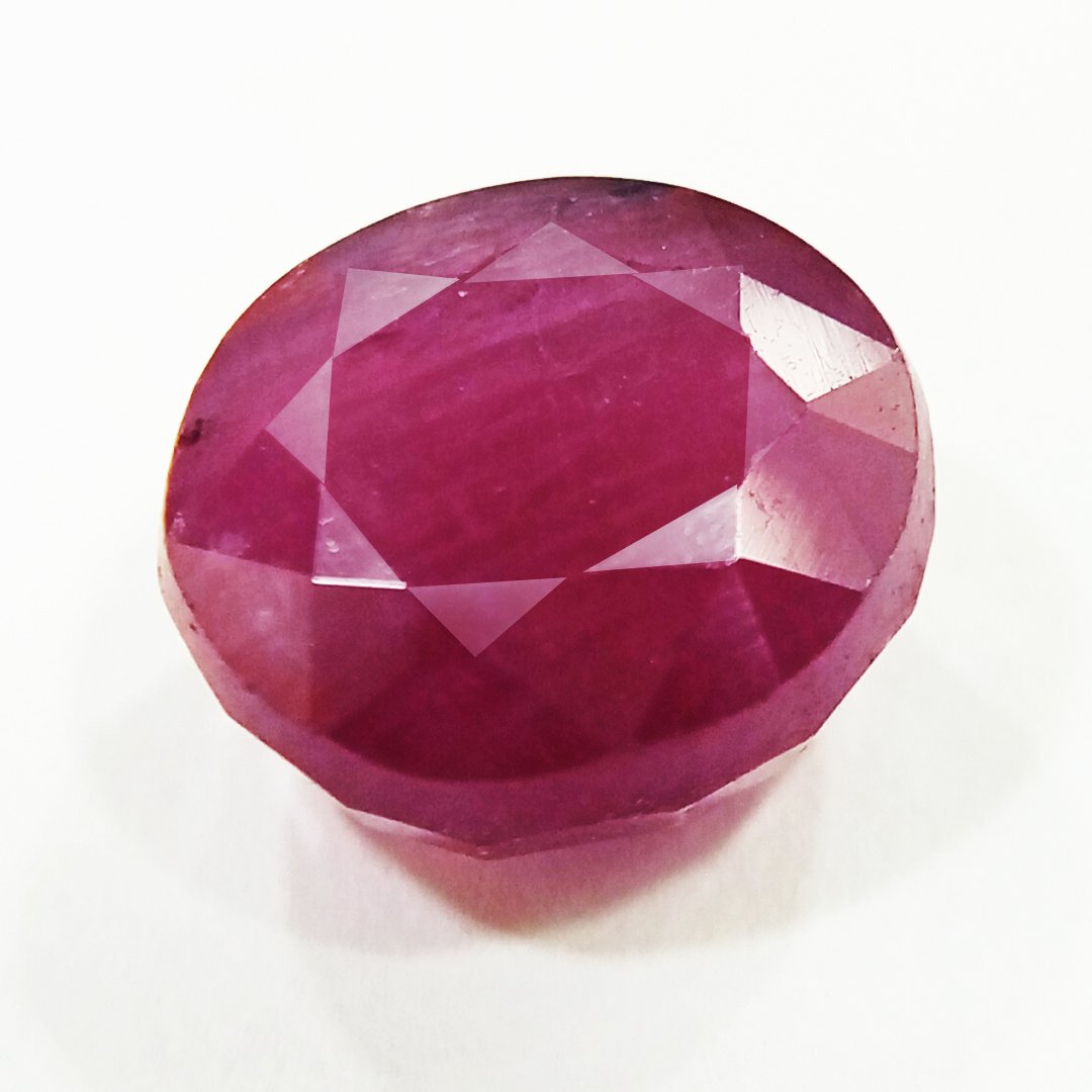 A close-up of a Natural African Ruby gemstone showcasing its rich red hue and brilliant clarity.