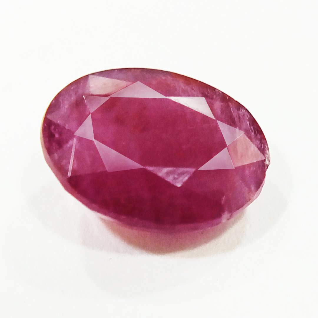 A close-up of a Natural African Ruby gemstone showcasing its rich red hue and brilliant clarity.