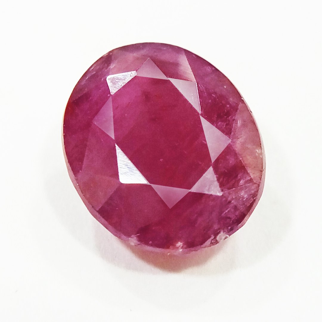 A close-up of a Natural African Ruby gemstone showcasing its rich red hue and brilliant clarity.