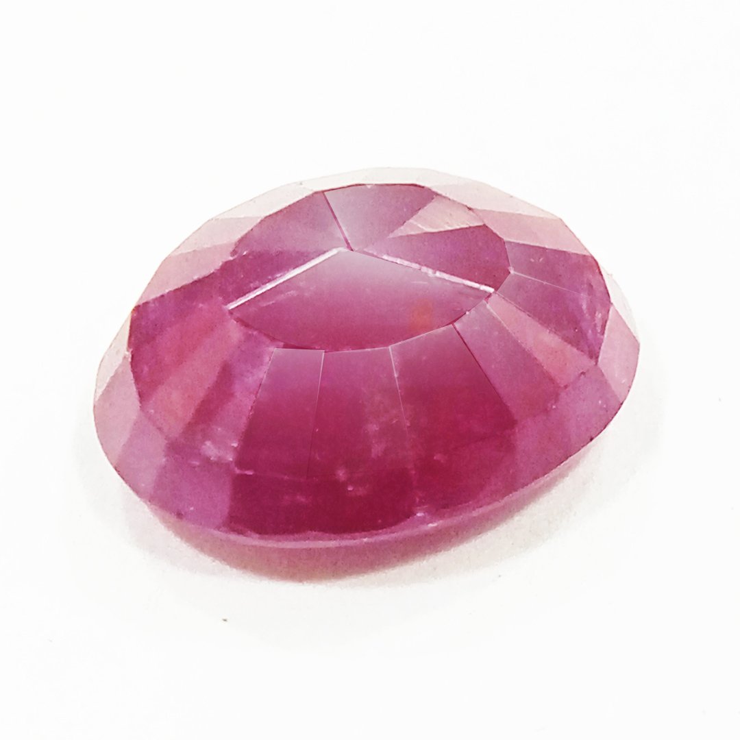 A close-up of a Natural African Ruby gemstone showcasing its rich red hue and brilliant clarity.