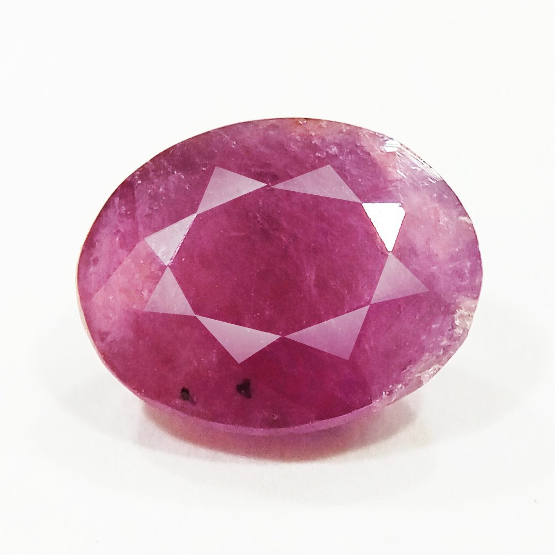 A close-up of a Natural African Ruby gemstone showcasing its rich red hue and brilliant clarity.