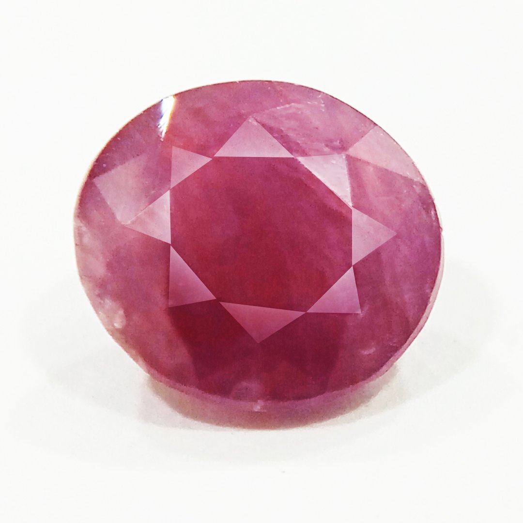 A close-up of a Natural African Ruby gemstone showcasing its rich red hue and brilliant clarity.