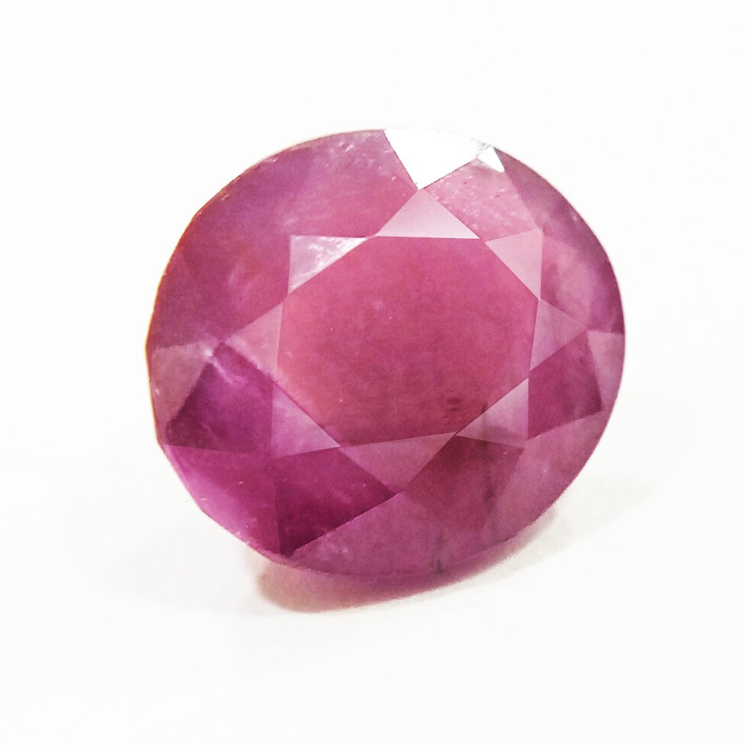 A close-up of a Natural African Ruby gemstone showcasing its rich red hue and brilliant clarity.