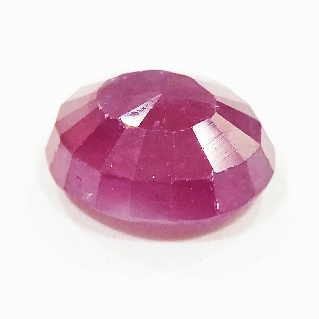 A close-up of a Natural African Ruby gemstone showcasing its rich red hue and brilliant clarity.