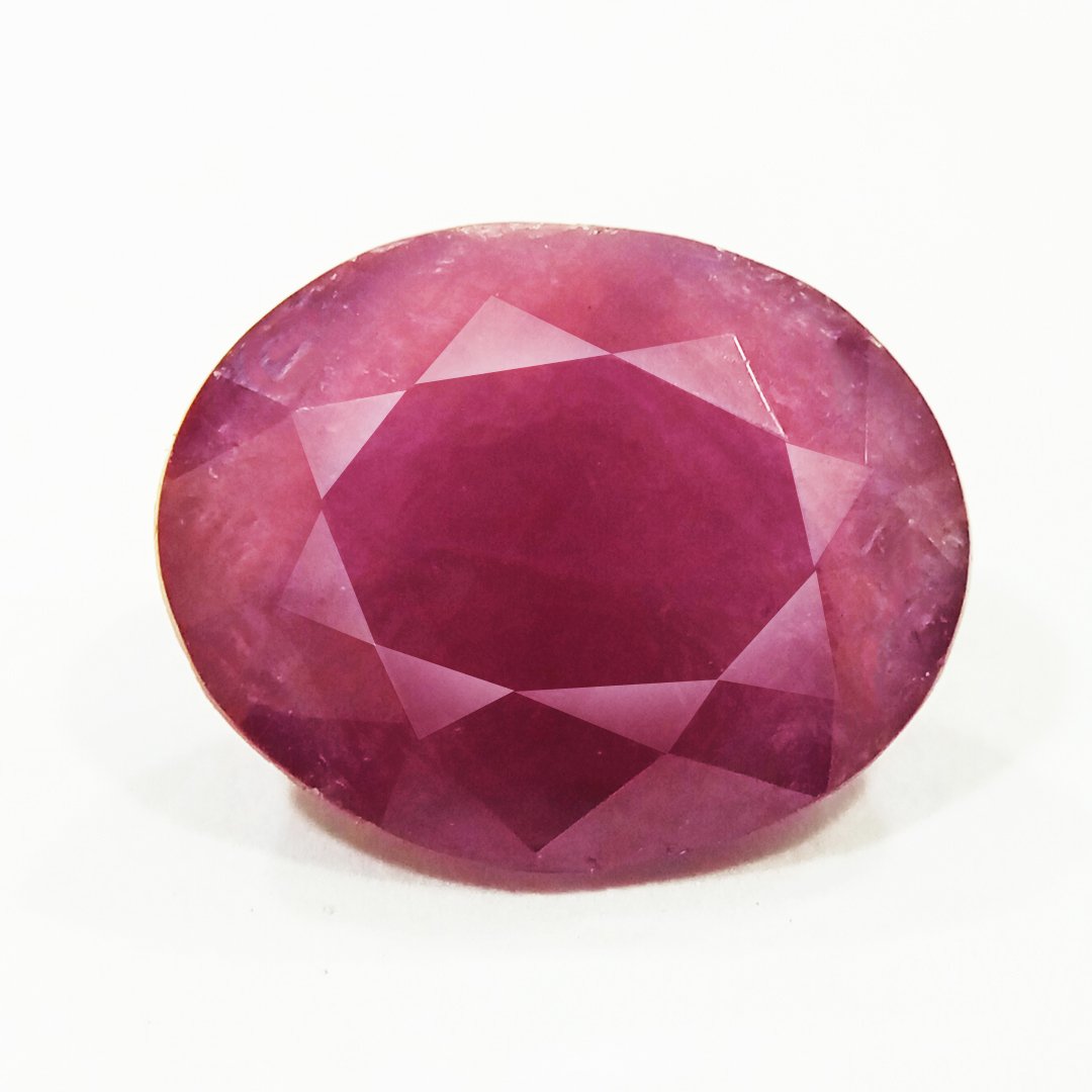 A close-up of a Natural African Ruby gemstone showcasing its rich red hue and brilliant clarity.