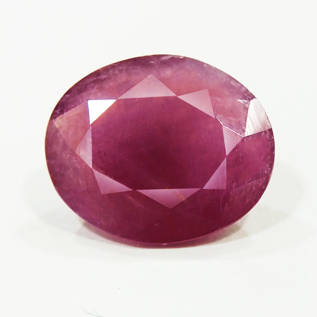 A close-up of a Natural African Ruby gemstone showcasing its rich red hue and brilliant clarity.