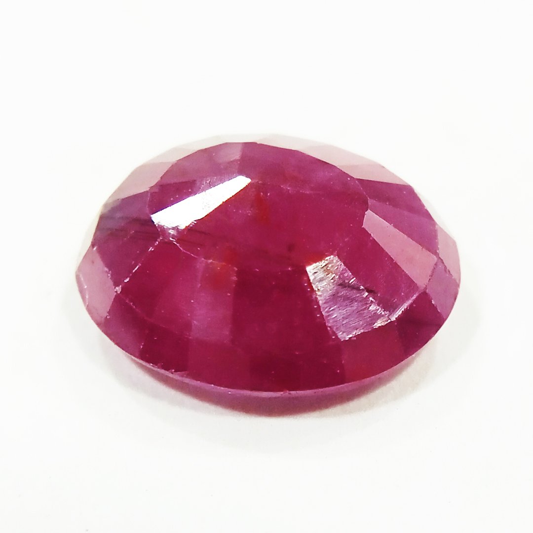 A close-up of a Natural African Ruby gemstone showcasing its rich red hue and brilliant clarity.