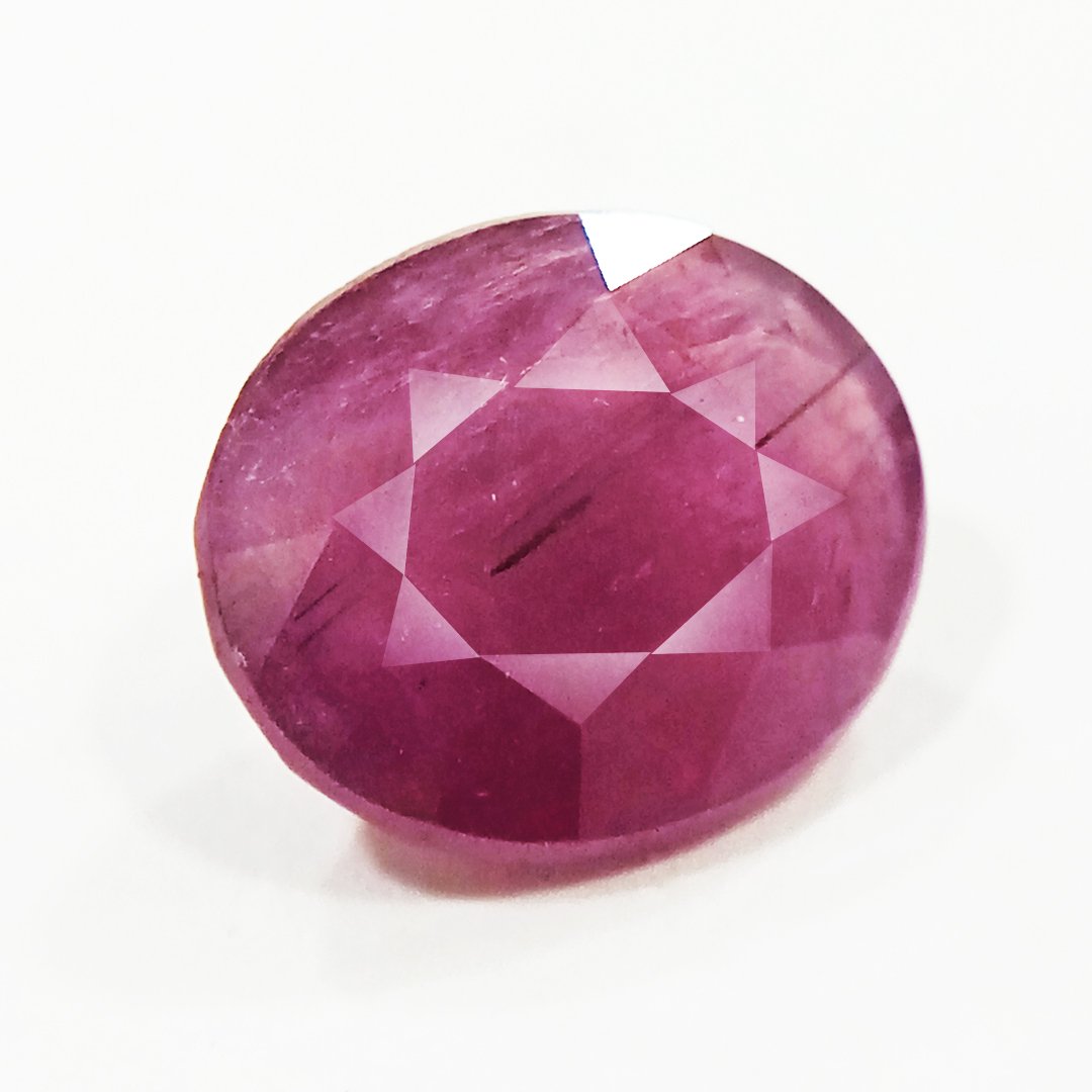 A close-up of a Natural African Ruby gemstone showcasing its rich red hue and brilliant clarity.