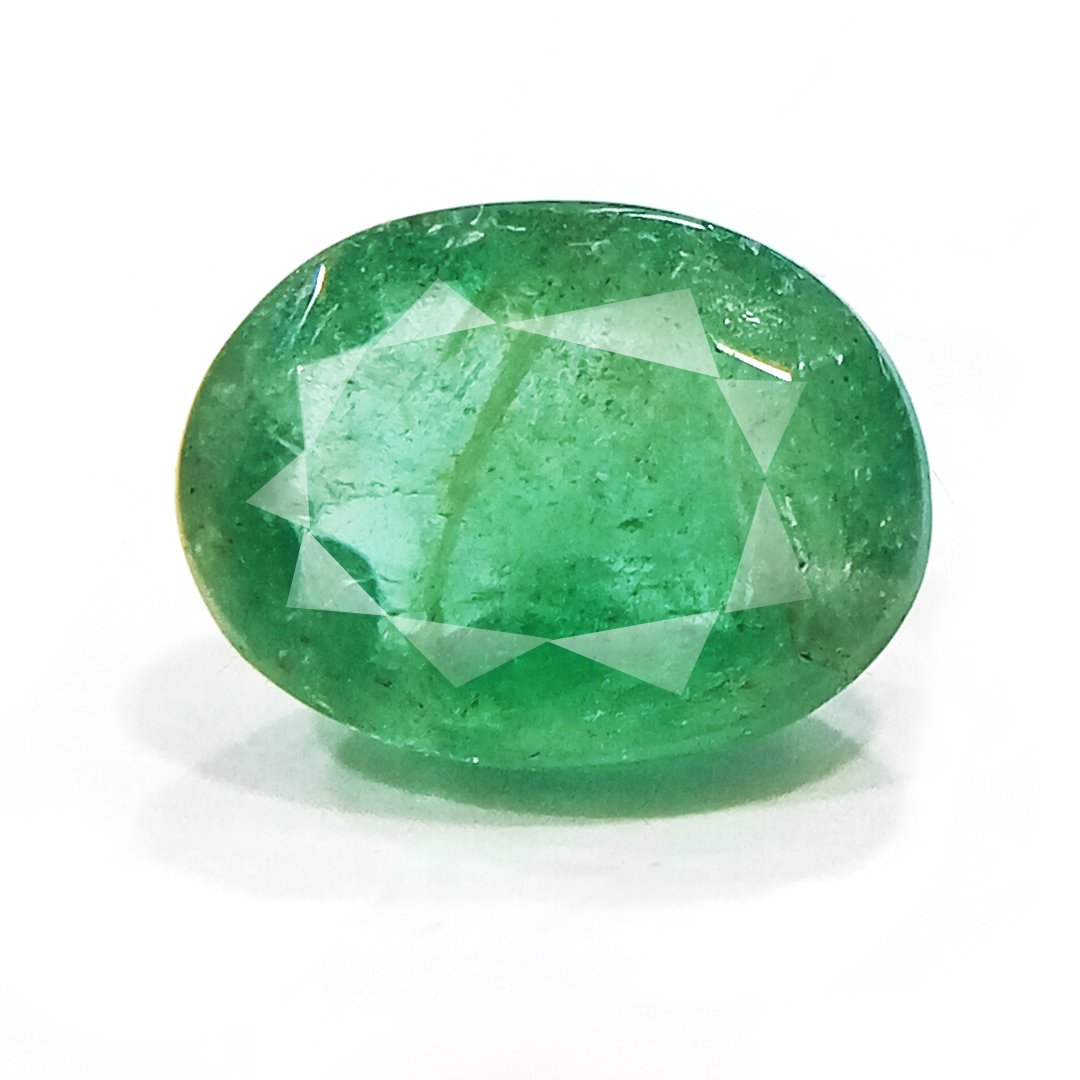 "Close-up of a radiant Zambian Emerald showcasing its vibrant green color and faceted cut."