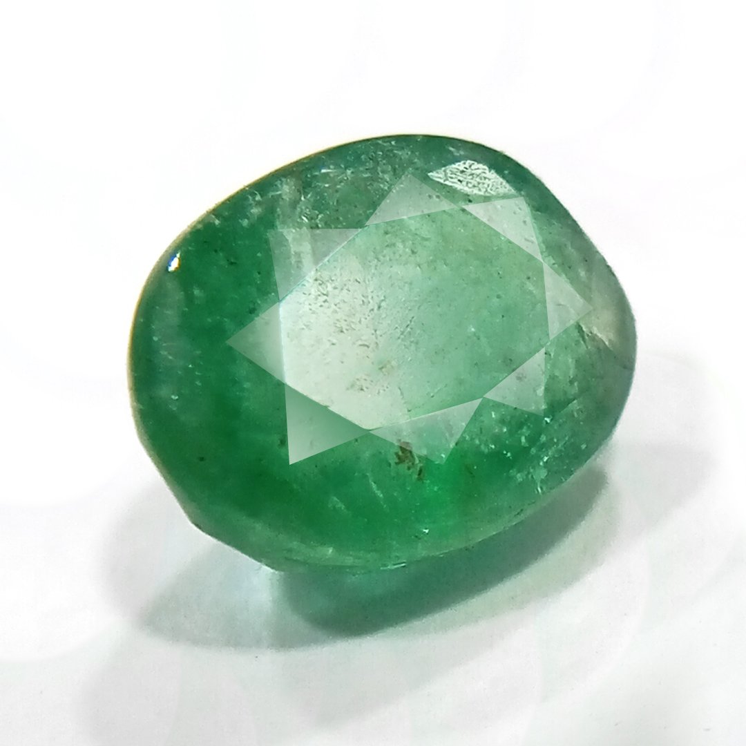 "Close-up of a radiant Zambian Emerald showcasing its vibrant green color and faceted cut."