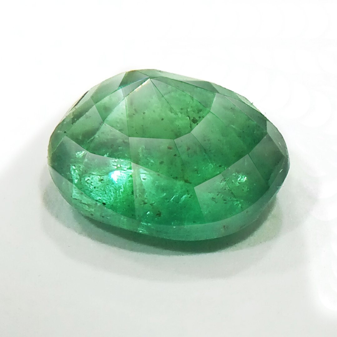 "Close-up of a radiant Zambian Emerald showcasing its vibrant green color and faceted cut."