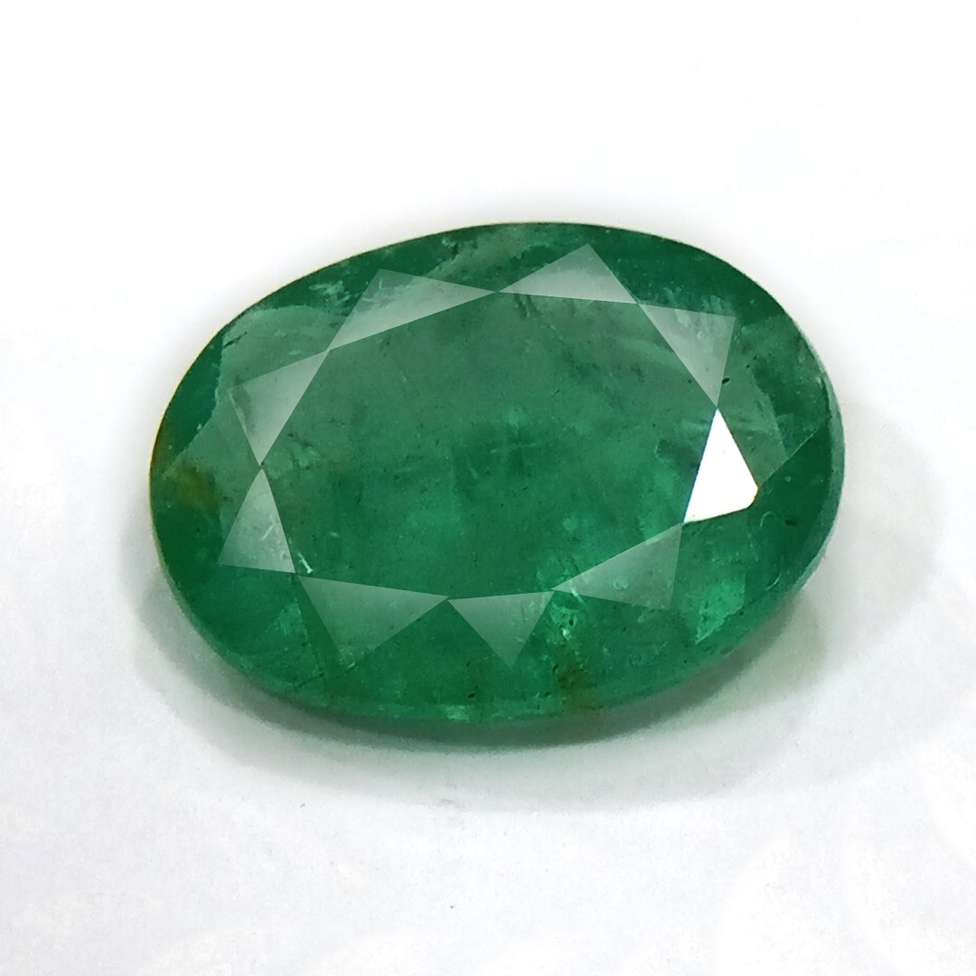 "Close-up of a radiant Zambian Emerald showcasing its vibrant green color and faceted cut."