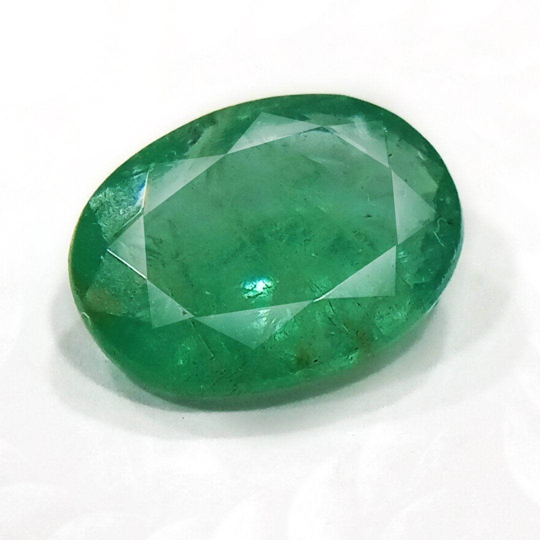 "Close-up of a radiant Zambian Emerald showcasing its vibrant green color and faceted cut."