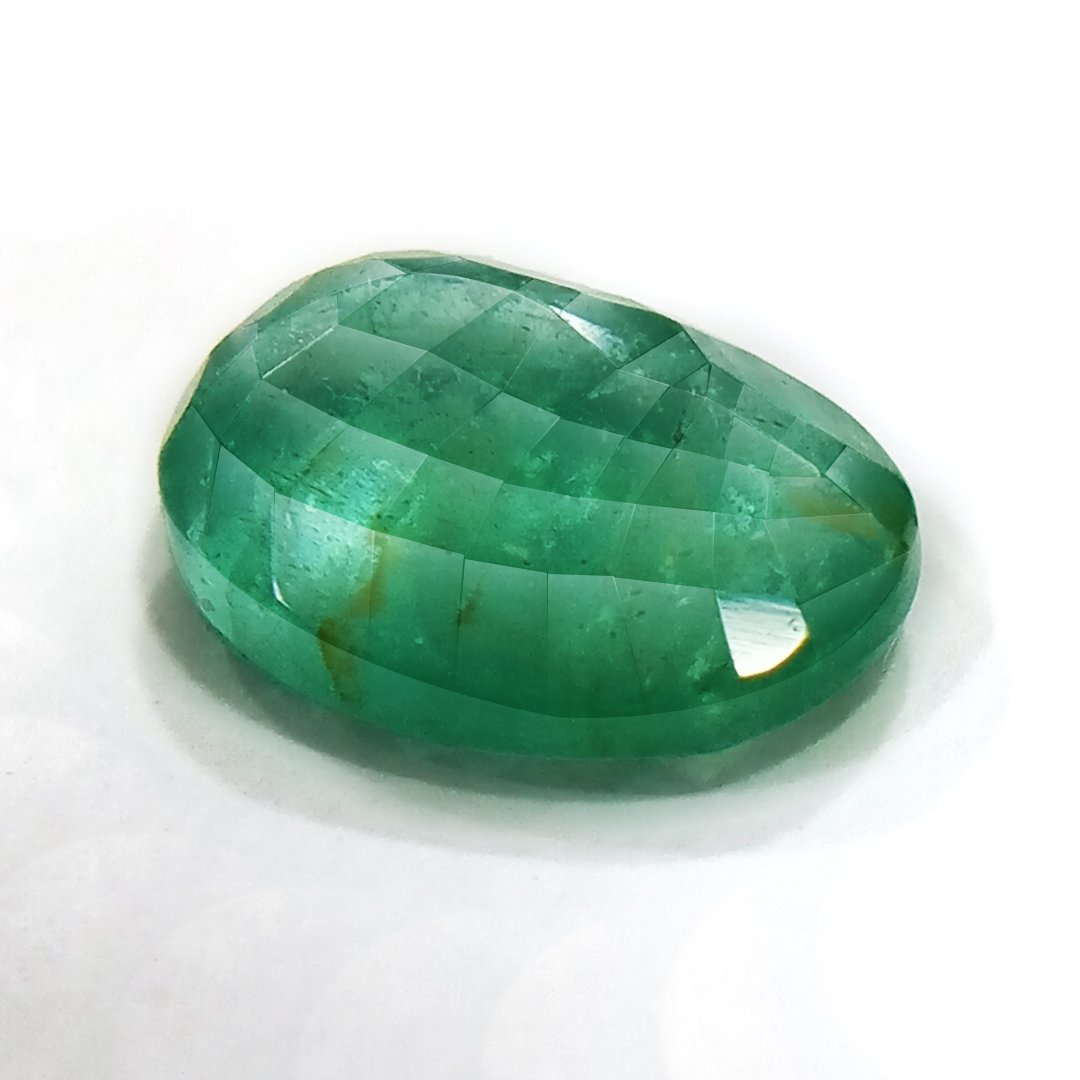 "Close-up of a radiant Zambian Emerald showcasing its vibrant green color and faceted cut."