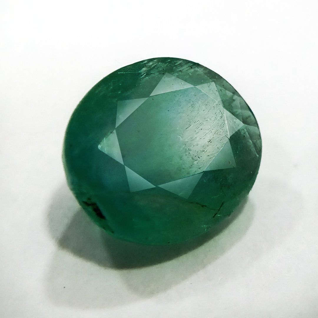 "Close-up of a radiant Zambian Emerald showcasing its vibrant green color and faceted cut."