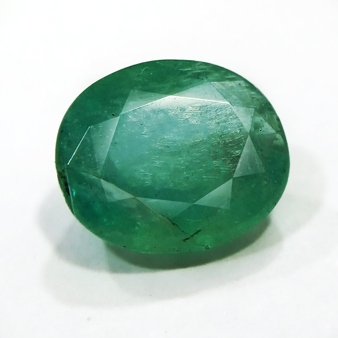 "Close-up of a radiant Zambian Emerald showcasing its vibrant green color and faceted cut."