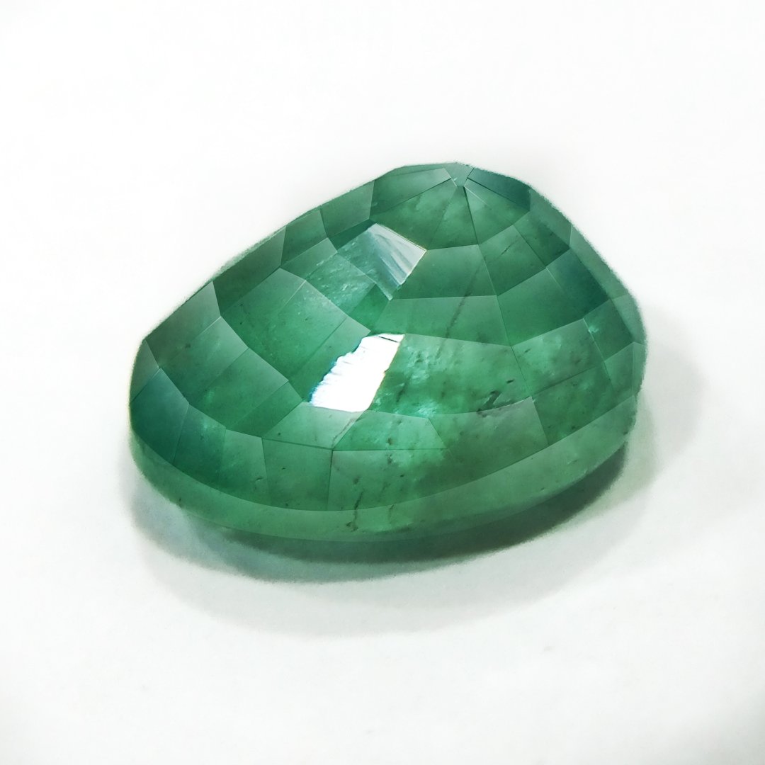 "Close-up of a radiant Zambian Emerald showcasing its vibrant green color and faceted cut."