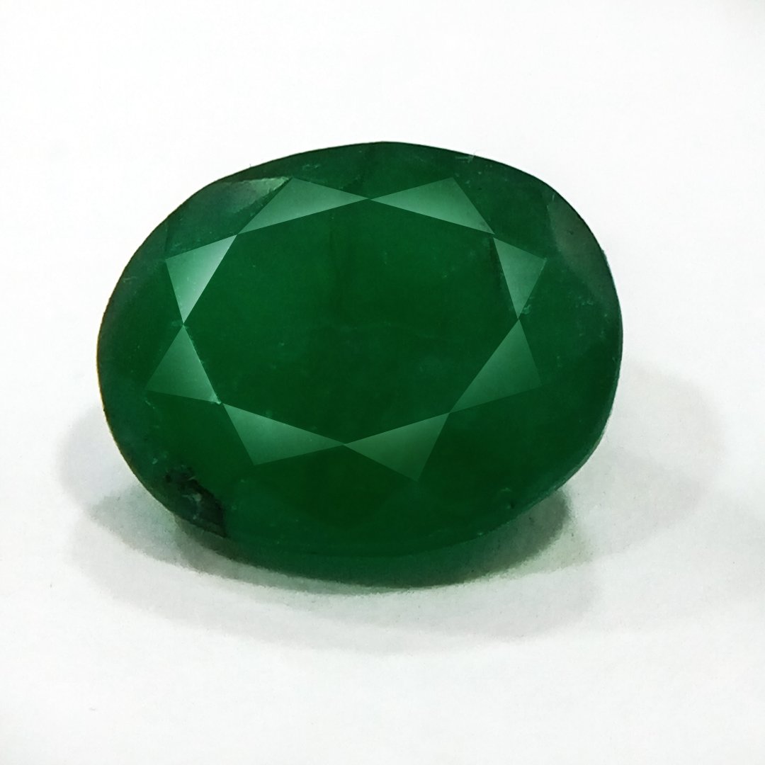 "Close-up of a radiant Zambian Emerald showcasing its vibrant green color and faceted cut."