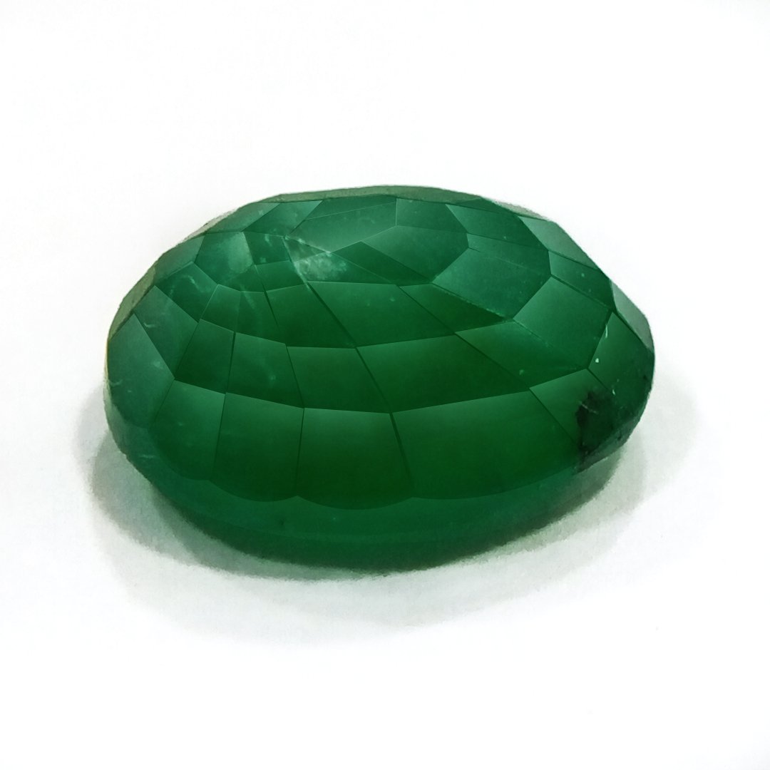 "Close-up of a radiant Zambian Emerald showcasing its vibrant green color and faceted cut."