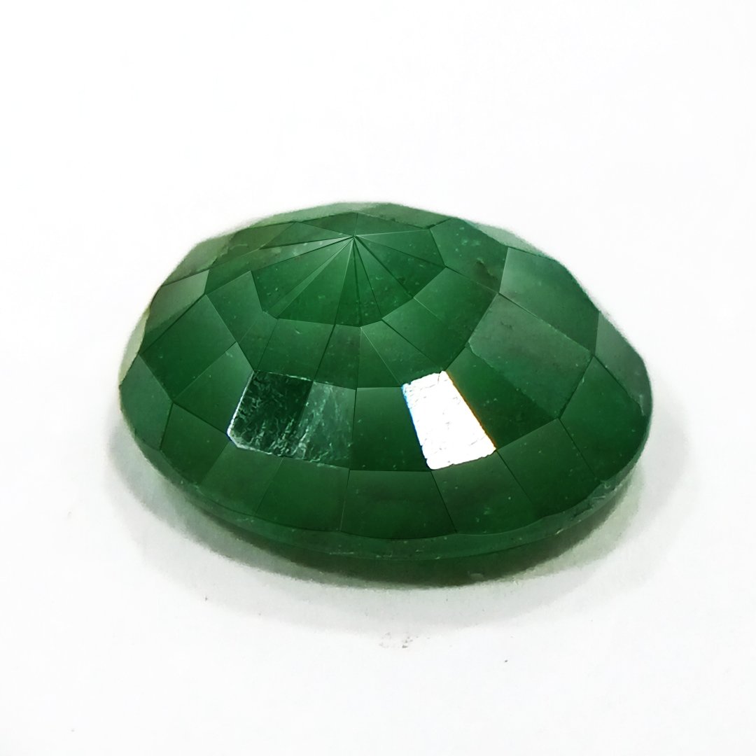 "Close-up of a radiant Zambian Emerald showcasing its vibrant green color and faceted cut."