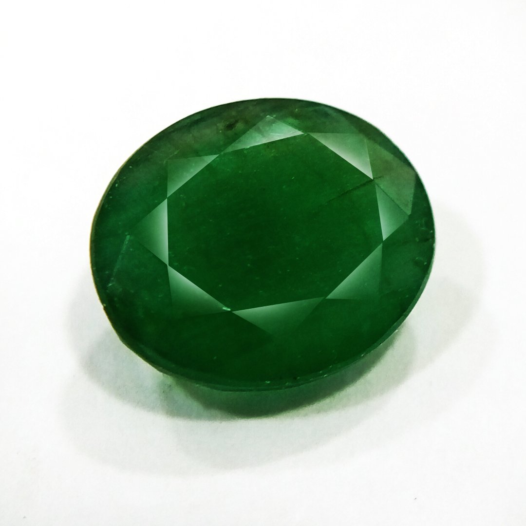 "Close-up of a radiant Zambian Emerald showcasing its vibrant green color and faceted cut."