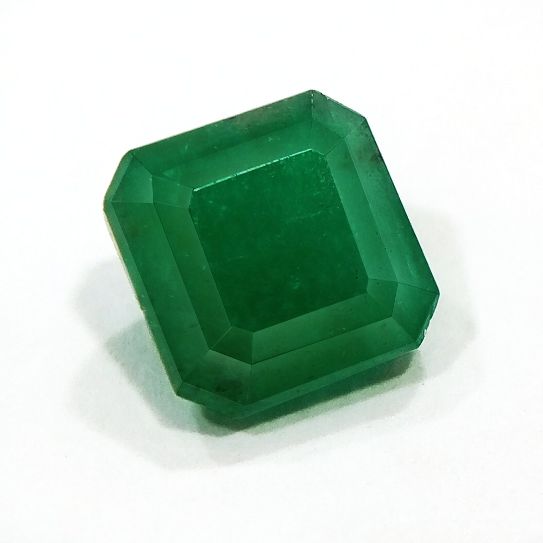 "Close-up of a radiant Zambian Emerald showcasing its vibrant green color and faceted cut."