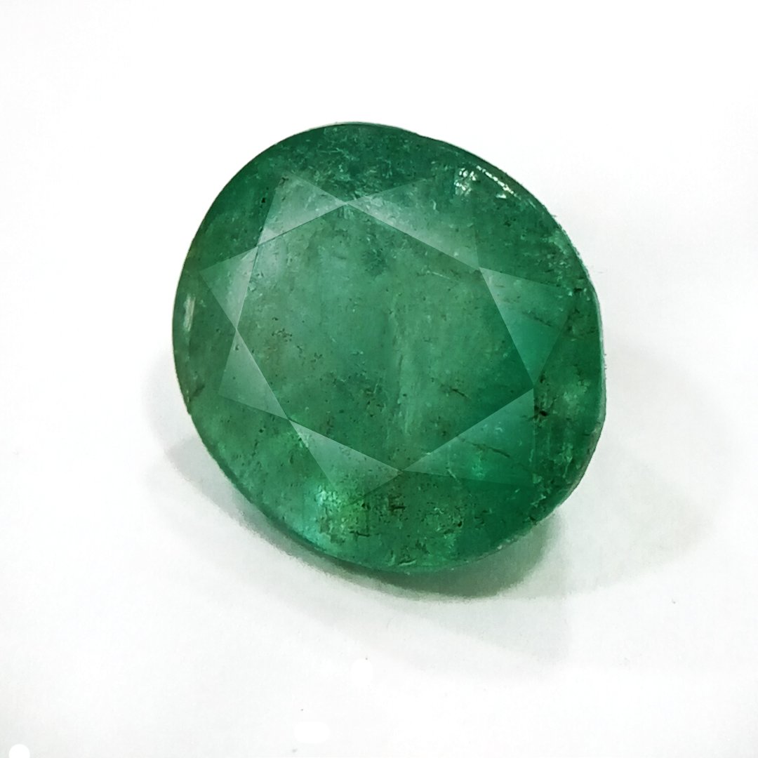 "Close-up of a radiant Zambian Emerald showcasing its vibrant green color and faceted cut."