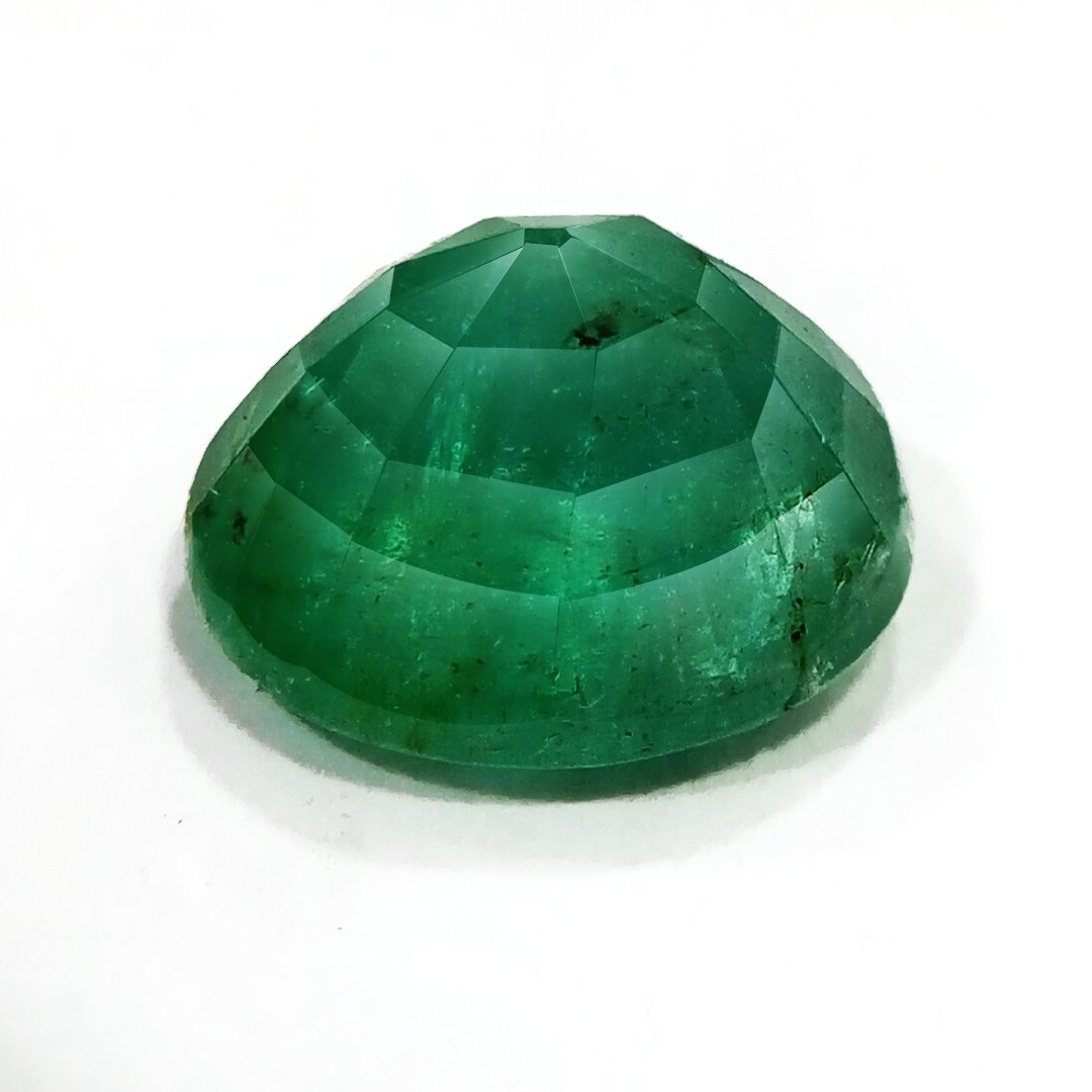 "Close-up of a radiant Zambian Emerald showcasing its vibrant green color and faceted cut."