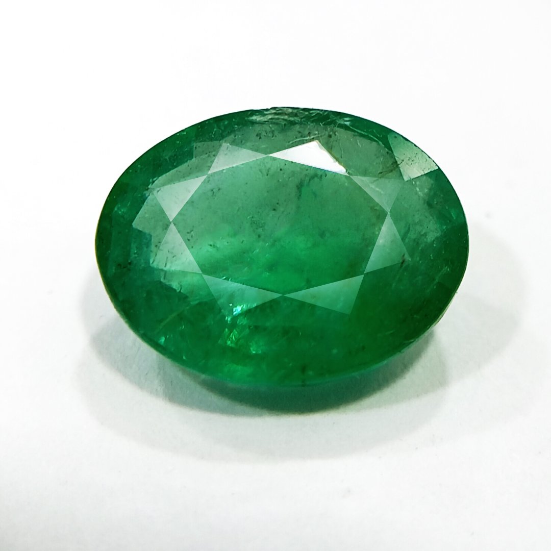 "Close-up of a radiant Zambian Emerald showcasing its vibrant green color and faceted cut."