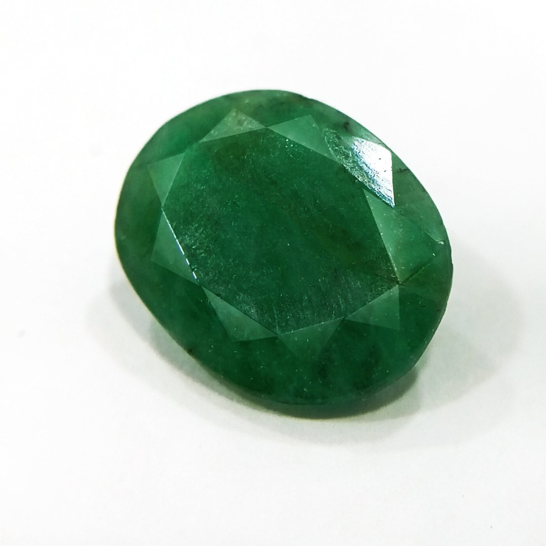 "Close-up of a radiant Zambian Emerald showcasing its vibrant green color and faceted cut."