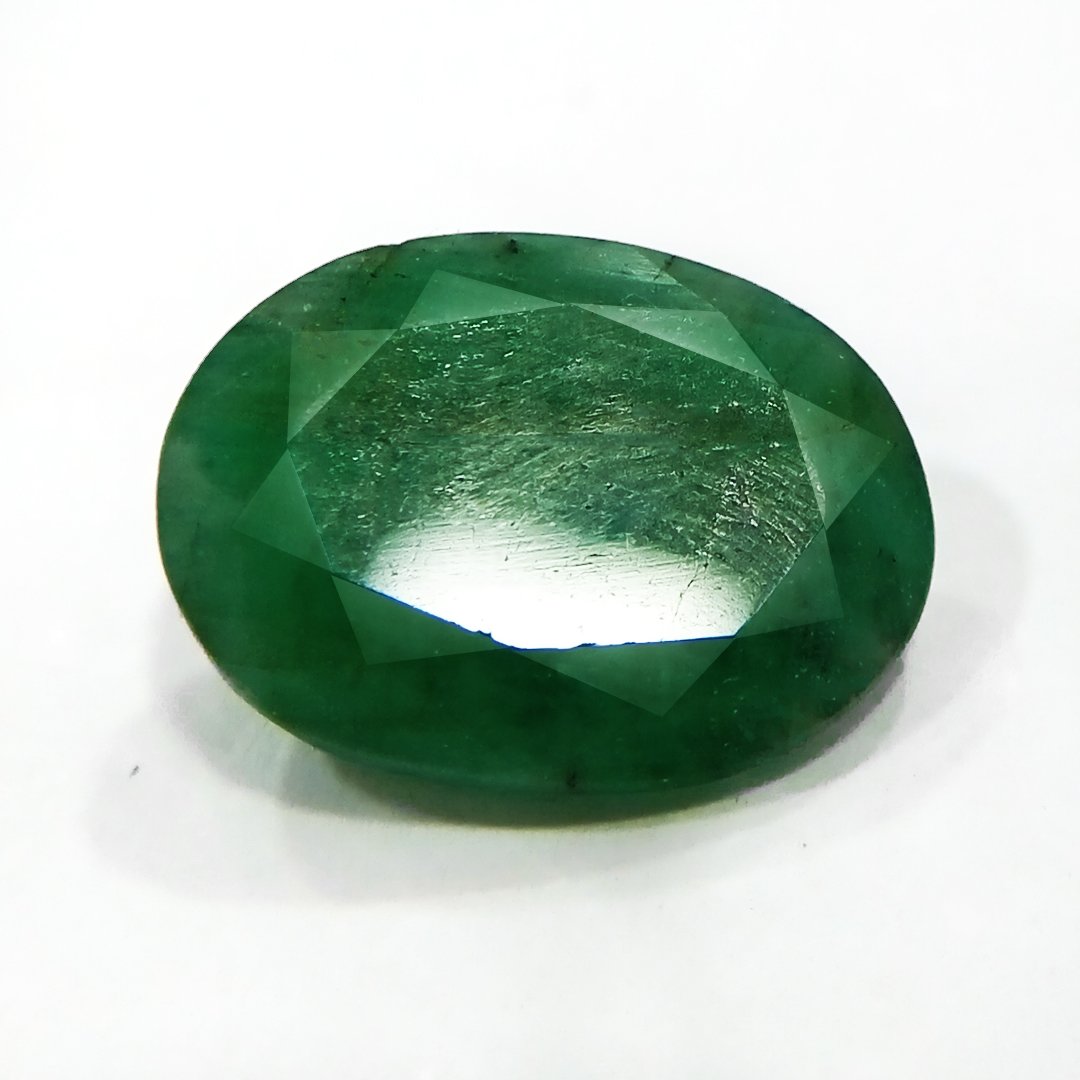 "Close-up of a radiant Zambian Emerald showcasing its vibrant green color and faceted cut."