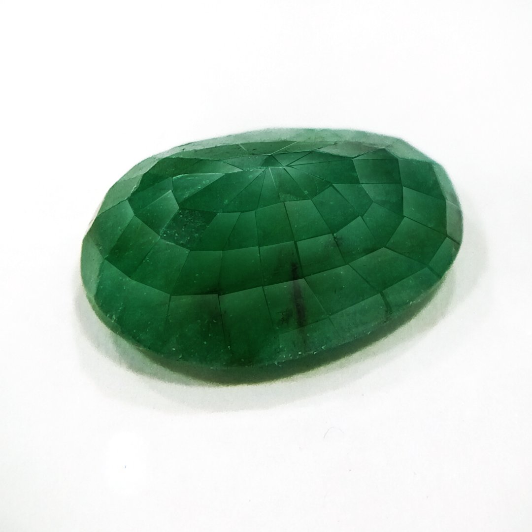 "Close-up of a radiant Zambian Emerald showcasing its vibrant green color and faceted cut."