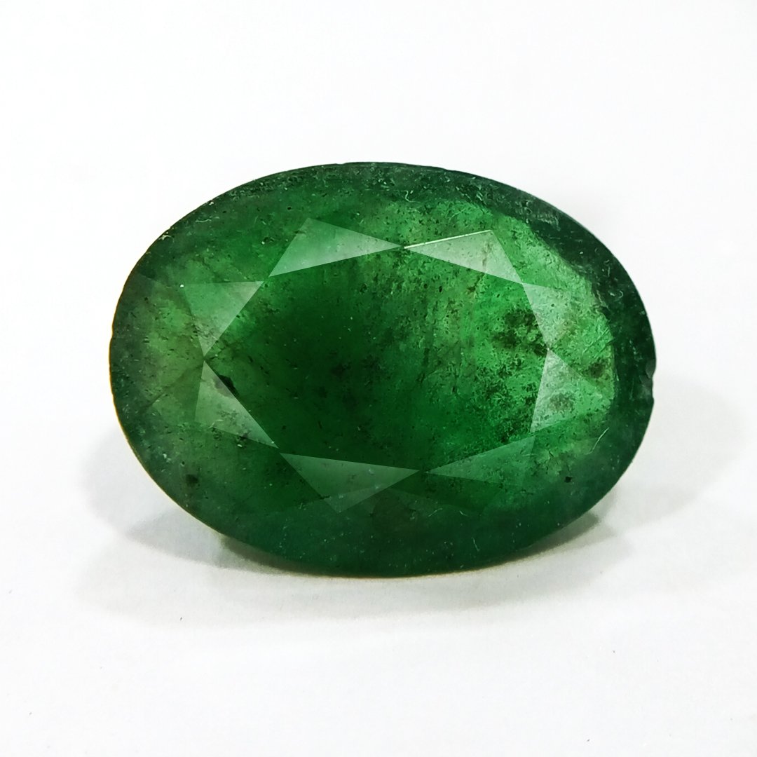"Close-up of a radiant Zambian Emerald showcasing its vibrant green color and faceted cut."