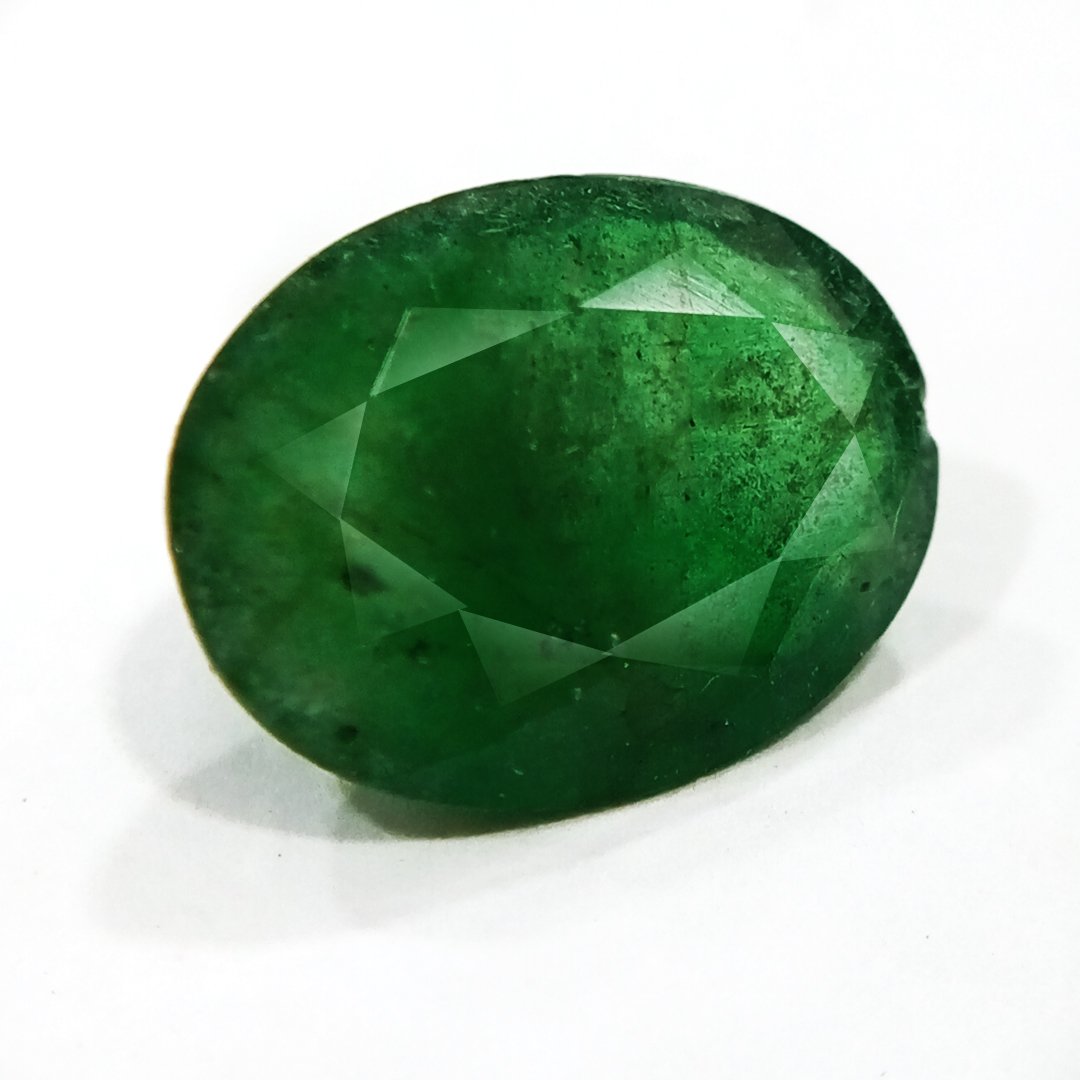 "Close-up of a radiant Zambian Emerald showcasing its vibrant green color and faceted cut."