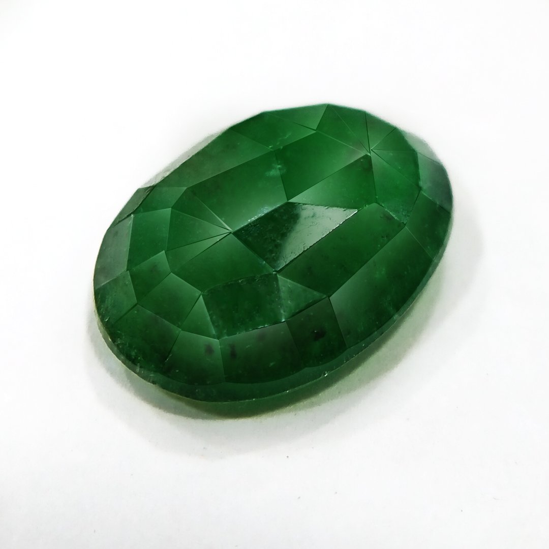"Close-up of a radiant Zambian Emerald showcasing its vibrant green color and faceted cut."