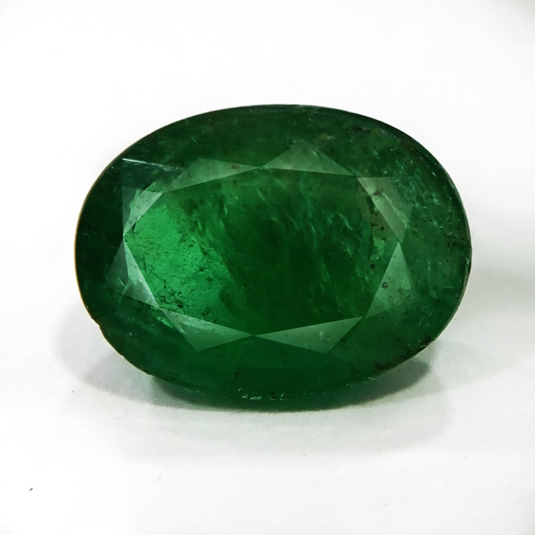 "Close-up of a radiant Zambian Emerald showcasing its vibrant green color and faceted cut."