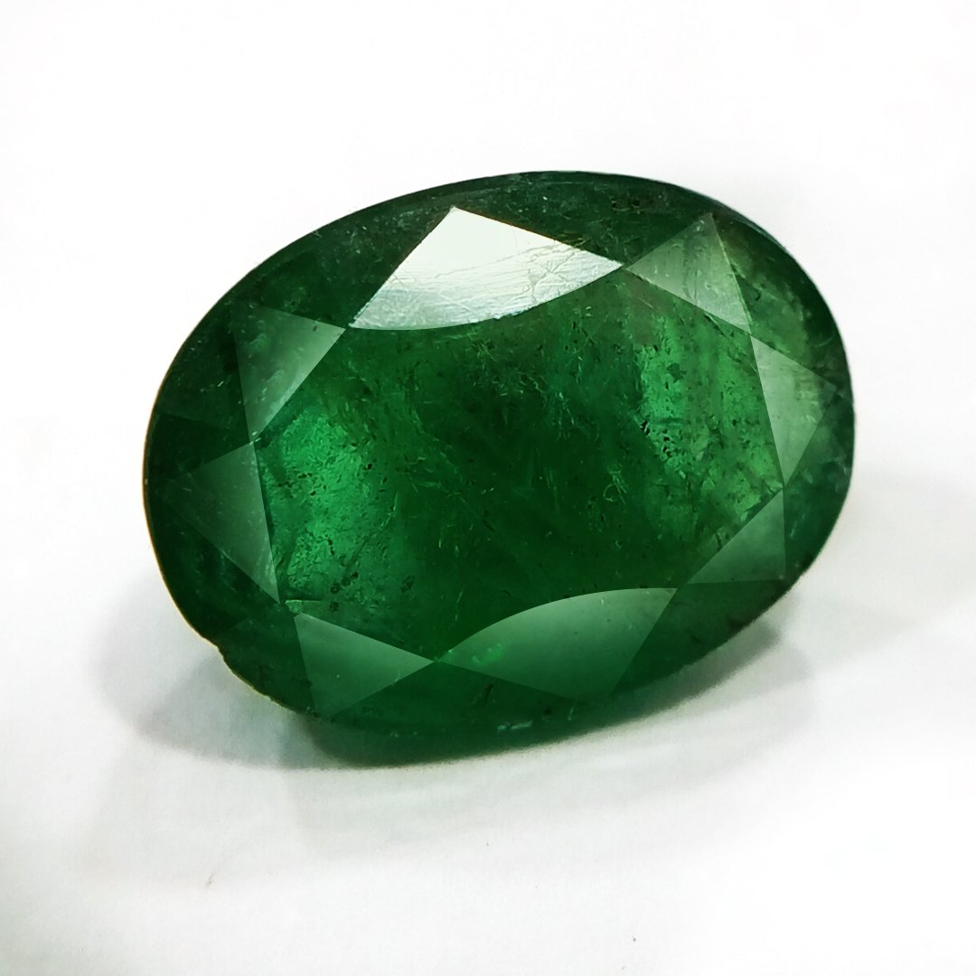 "Close-up of a radiant Zambian Emerald showcasing its vibrant green color and faceted cut."