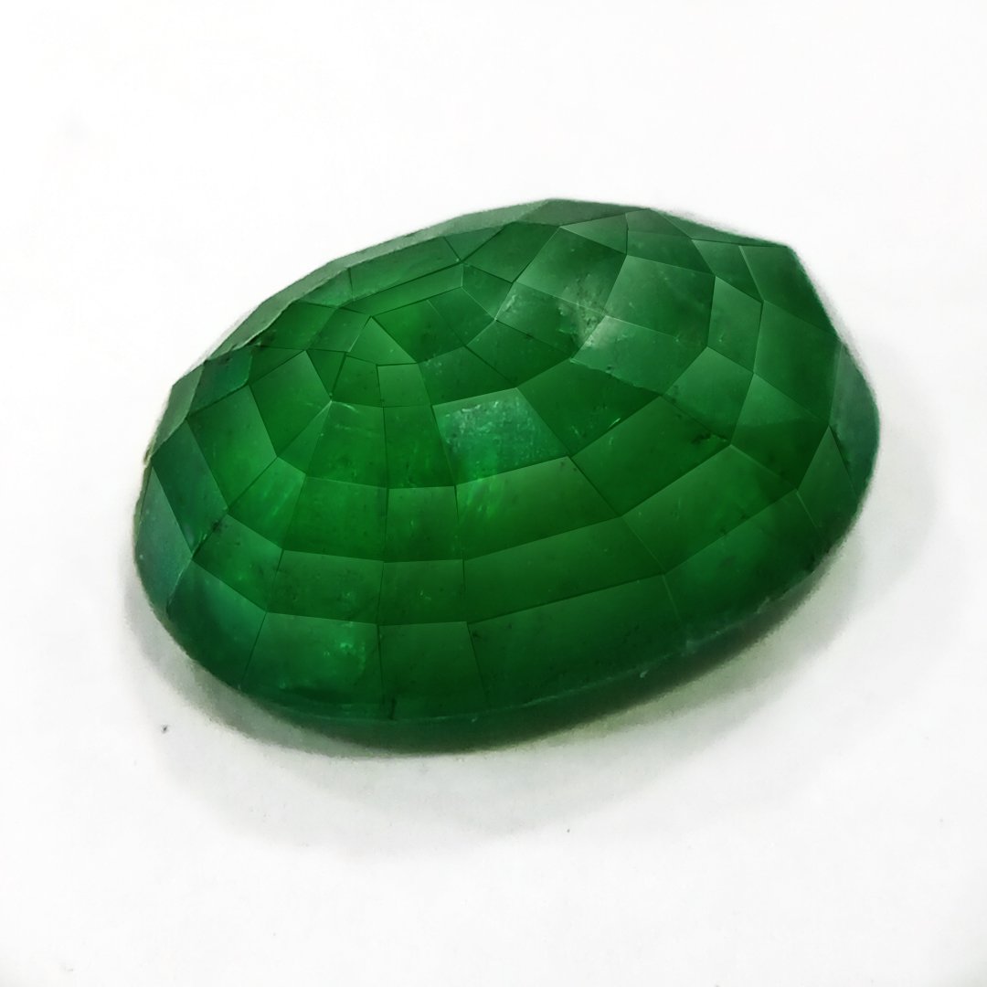 "Close-up of a radiant Zambian Emerald showcasing its vibrant green color and faceted cut."