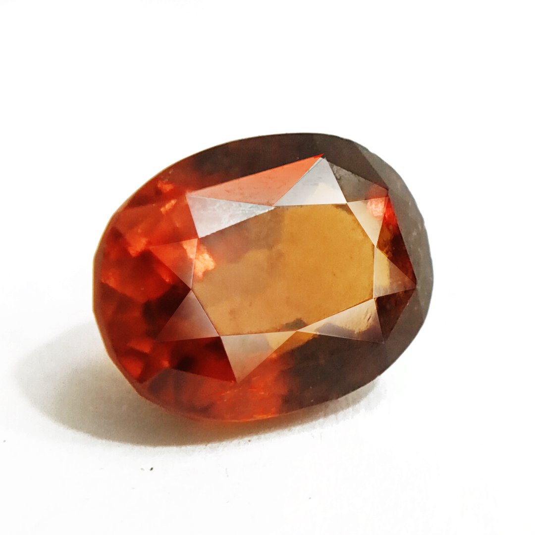 A close-up of a Natural African Gomedh (Hessonite Garnet) gemstone with a deep reddish-brown hue and radiant clarity.
